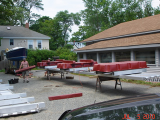 floating walkway under construction.  Wooden 4x4's protect the bottom of the float drums.